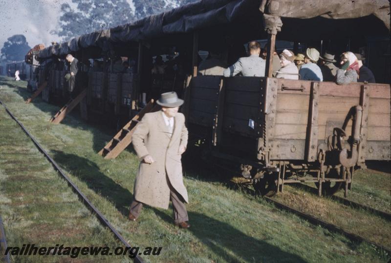 T01953
Passengers in covered open wagons on tour train
