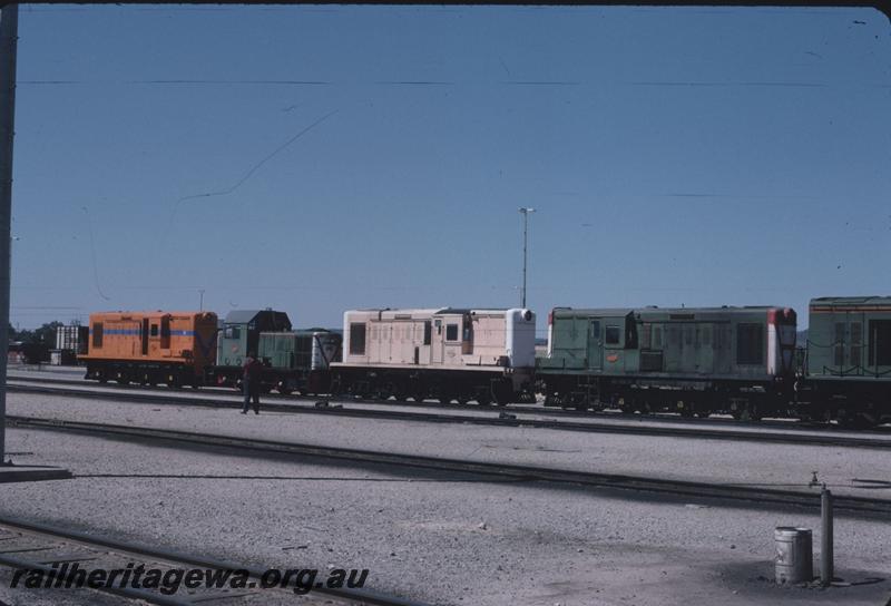 T02787
Y classes and a B class lined up at Forrestfield Yard, Left to right, Y class 1115 in Westrail orange livery but without the white pinstriping, B class 1605, Y class 1110 in pink livery with white ends and Y class 1111 in green livery, side and front views.
