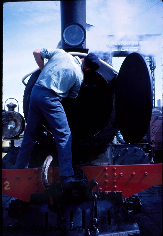 T03365
G class 112, crew member cleaning out the smoke box, Bunbury loco depot, used on ARHS tour train
