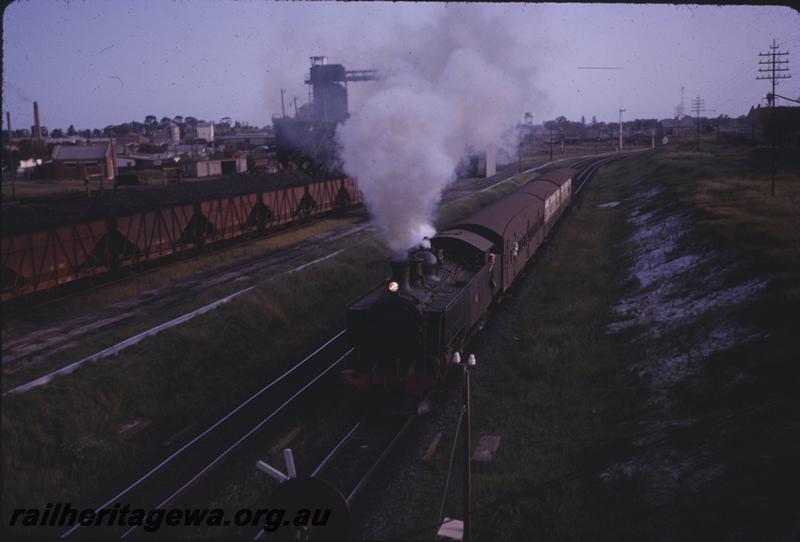 T04198
DD class 599, XA class bogie coal hoppers, East Perth, suburban passenger passing the coal stage at the East Perth loco depot.
