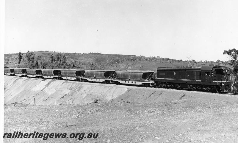 P00320
A class 1506 hauling a train of loaded XB class bauxite hoppers on the Kwinana to Jarrahdale line en route to Alcoa's alumina plant at Kwinana, loco and wagons as new
