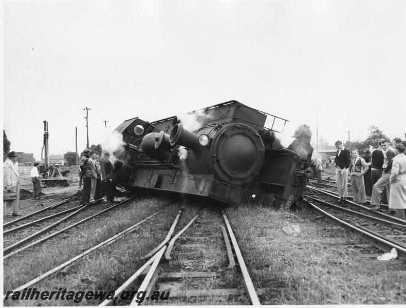 P00444
2 of 4 views of DM class 585 on No. 195 Passenger  derailed and lying on its side, Midland Junction, side and front view, date of derailment 30/7/1953
