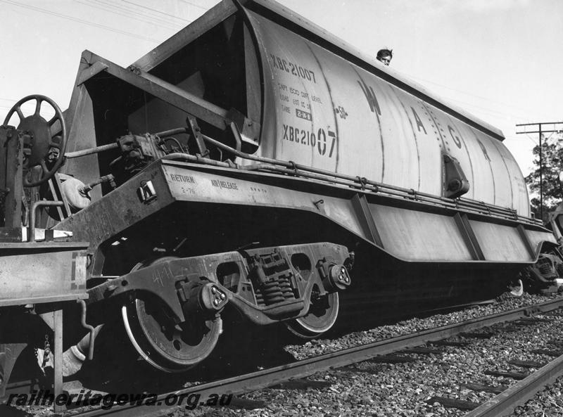 P00448
2 of 4 views of the derailment of a loaded bauxite train at Mundijong, XBC class 21007 bauxite hopper, derailed and on a lean, end and side view.
