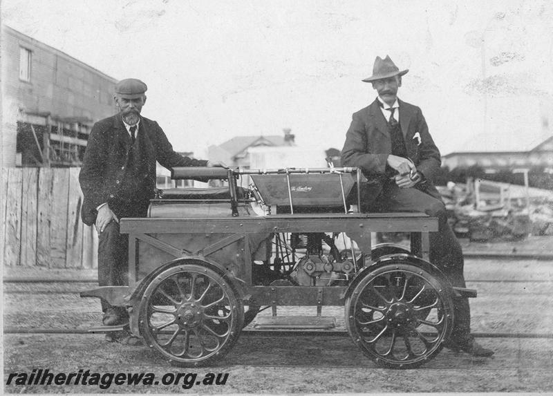 P00526
Ganger's trolley, early version, motorised, two operators on the trolley, side view.
