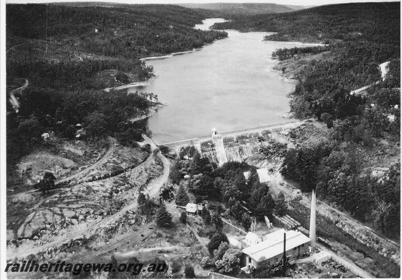 P00590
Mundaring Weir, aerial view taken from a RAAF aircraft. Shows the zig zag leading down to the pumping station
