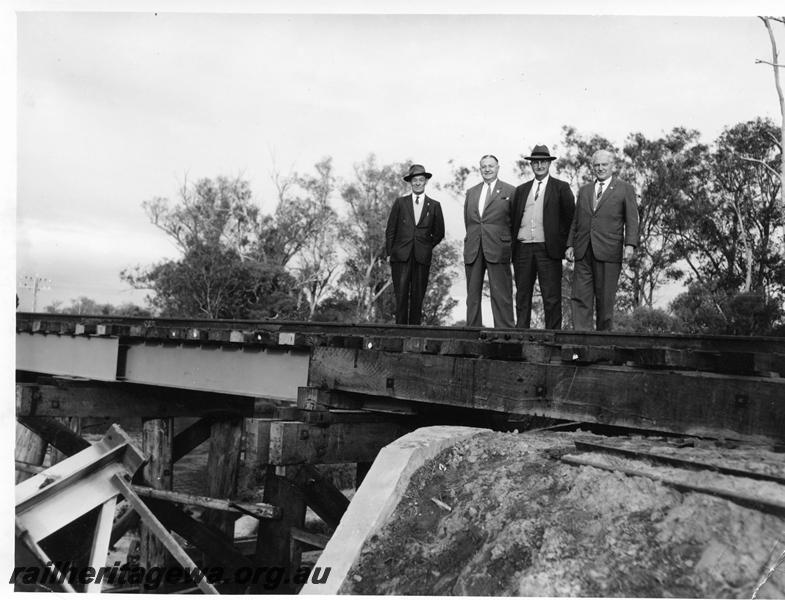 P00772
Trestle bridge with steel girders over the Preston River, PP line, Commissioner of Railways Mr. C. G. C. Wayne and other officials on bridge
