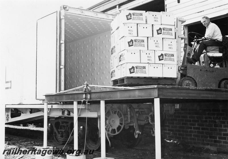 P00794
Apples being loaded into a container on a flat wagon, Bridgetown, PP line
