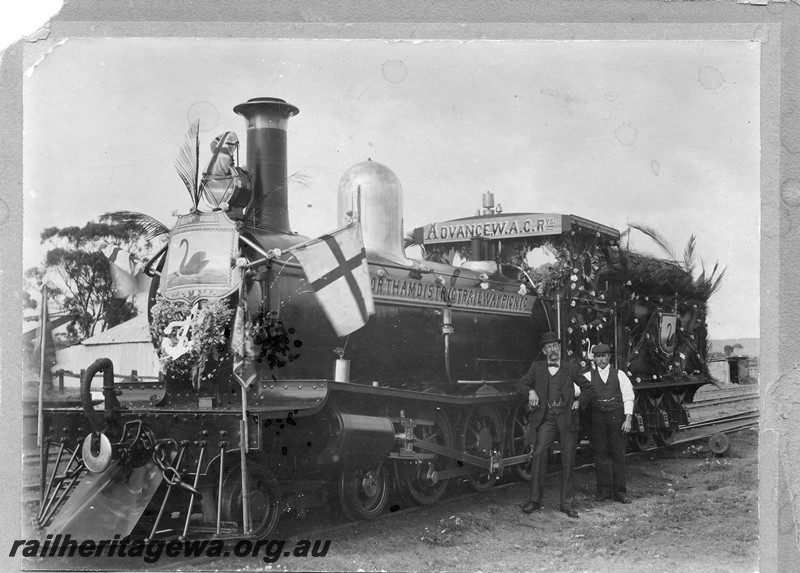 P01019
G class loco with railway personnel posed in front of cab, front and side view, Loco decorated for the 
