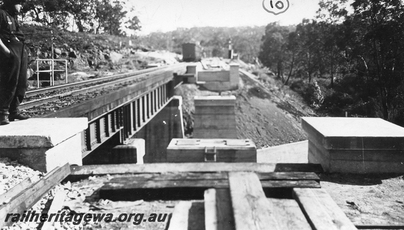 P01427
2 of 13 images of the construction of the duplicate steel girder bridge No.1 at 16 miles 25 chains on the ER through the John Forrest National Park, view along the line of the new bridge, existing bridge on the left hand side,
