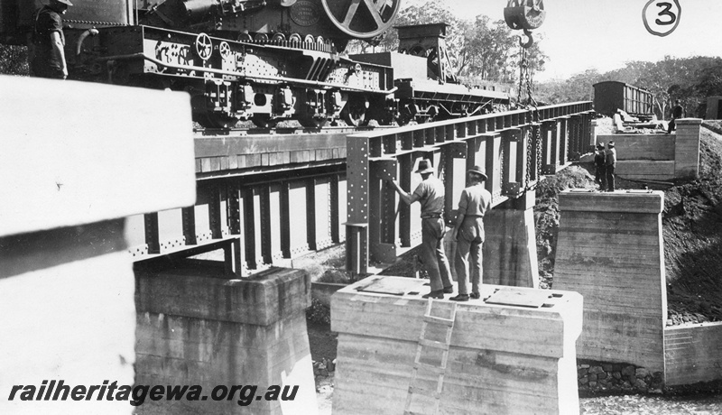 P01430
5 of 13 images of the construction of the duplicate steel girder bridge No.1 at 16 miles 25 chains on the ER through the John Forrest National Park, main girder being manoeuvred into its final position
