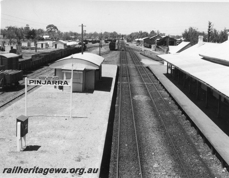 P01711
Station buildings Pinjarra, looking south from the footbridge, nameboard, loco and carriage sheds, water column, passenger platform, 