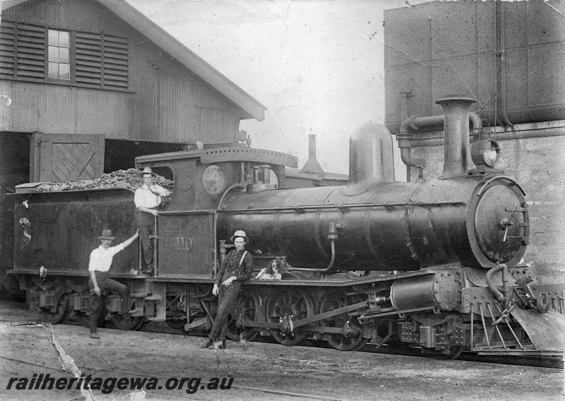 P01745
G class 110, Mullewa loco shed, side and front view, James Murrie standing near the tender, Wally King standing on the footplate was killed in WWI and Alick Hill standing next to the loco, 25,000 gallon cast iron  tank on masonry water tower, NR line.
