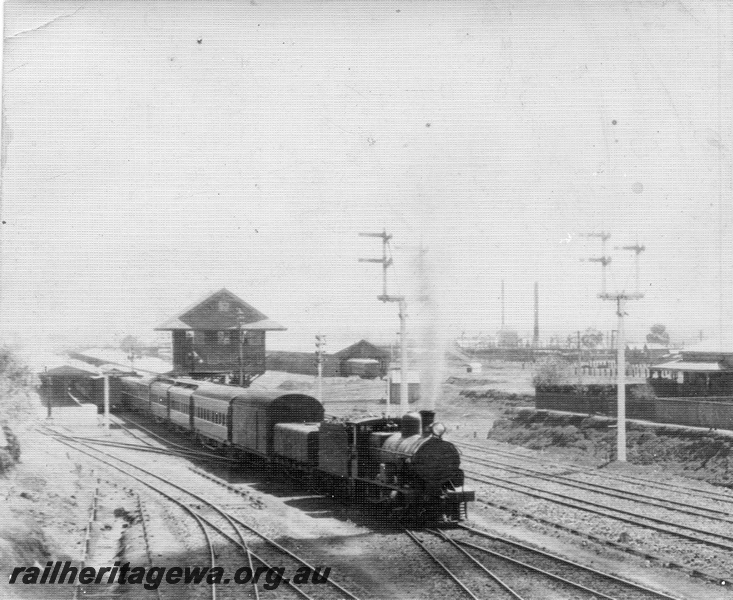P01761
Commonwealth Railways (CR) G class steam loco. signals, signal box, Kalgoorlie, TAR Line, view from the Maritana Street Bridge looking west, Trans train departing
