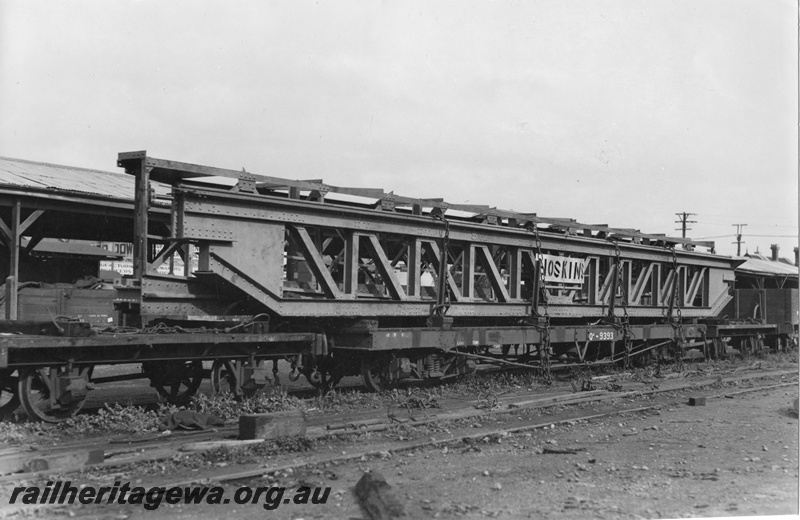 P01774
3 of 3 views of QA class 9393 bogie flat wagon carrying an over length electric crane traverser for the Great Boulder Mine, loaded at Perth Goods Yard, end and side view.
