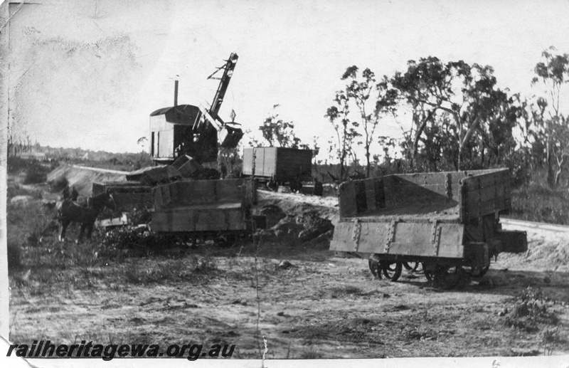 P02014
12 of 14. Ruston steam shovel, on embankment, 4 wheeled side tipping wagons, one wagon with side down showing interior of wagon, several wagons derailed, draught horse, side and front view, construction of Denmark-Nornalup railway, D line.
