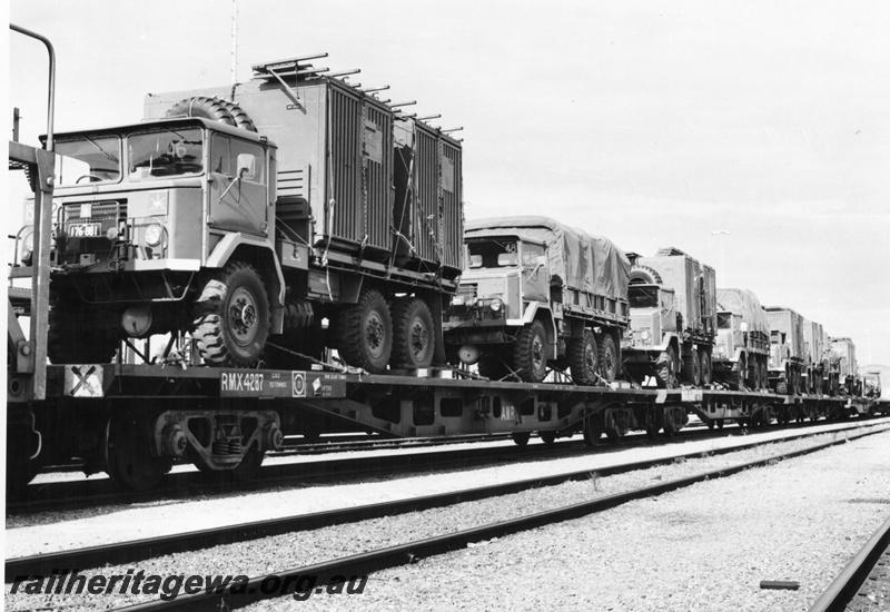 P02077
Army vehicles loaded onto ANR bogie flat wagons, view along the train
