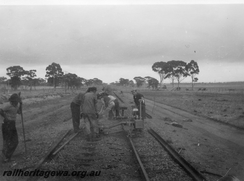P02113
4 of 7 views of the early relaying of the track on the EGR, c1950, gangers operating a machine, view along the track
