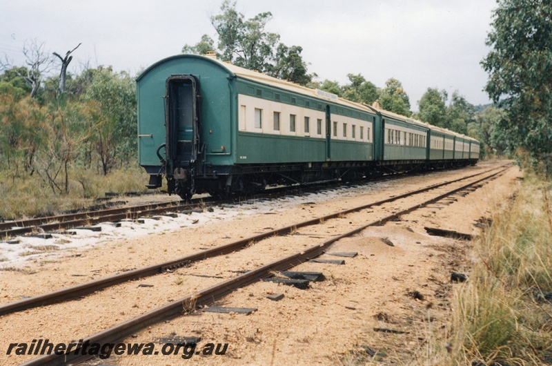 P02613
AZ class carriage of the Hotham Valley Railway carriages stowed in the siding at Isandra en route to Dwellingup, view along the rake of carriages.
