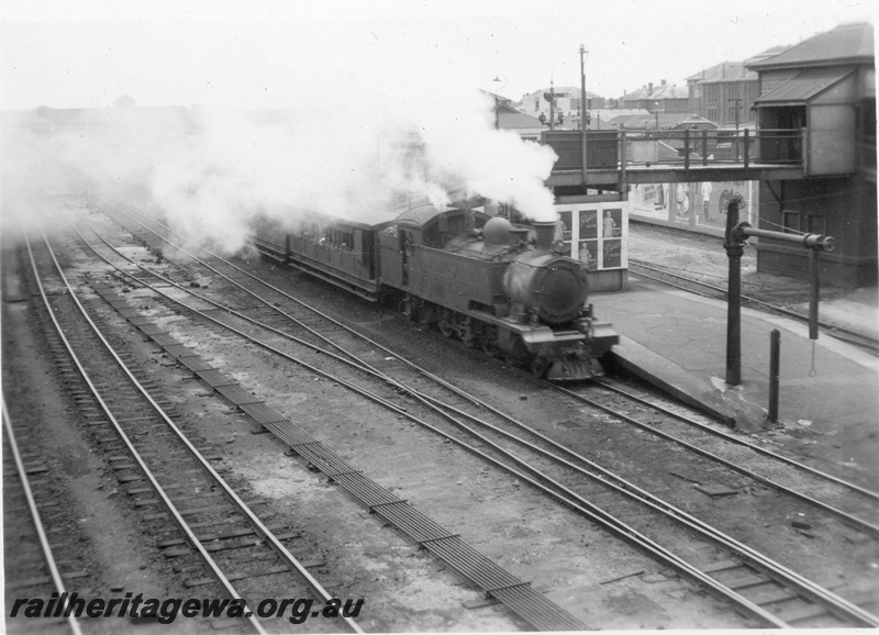 P02671
Ds class 373 4-6-4T steam locomotive on suburban passenger working, side and front view, water column on the end of the platform, Perth, ER line.
