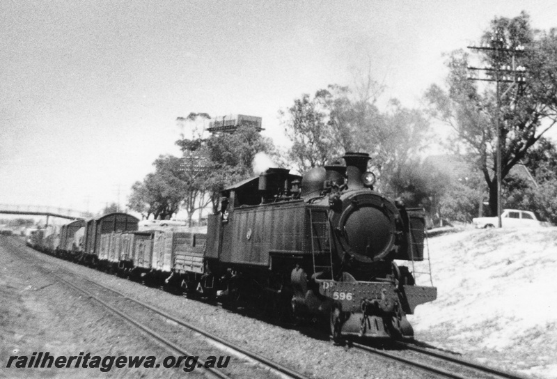 P03468
DD class 596 steam locomotive on a Down goods train, side and front view, water tower, footbridge, East Perth, ER line.
