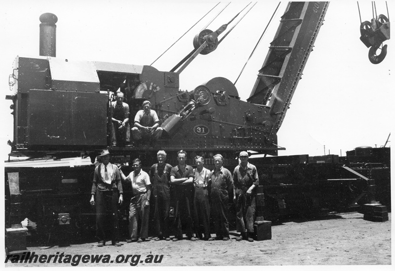 P03578
2 of 7 images of the Cowans Sheldon 60 ton breakdown crane No.31, view of cab and cylinder, workers standing in front of the crane
