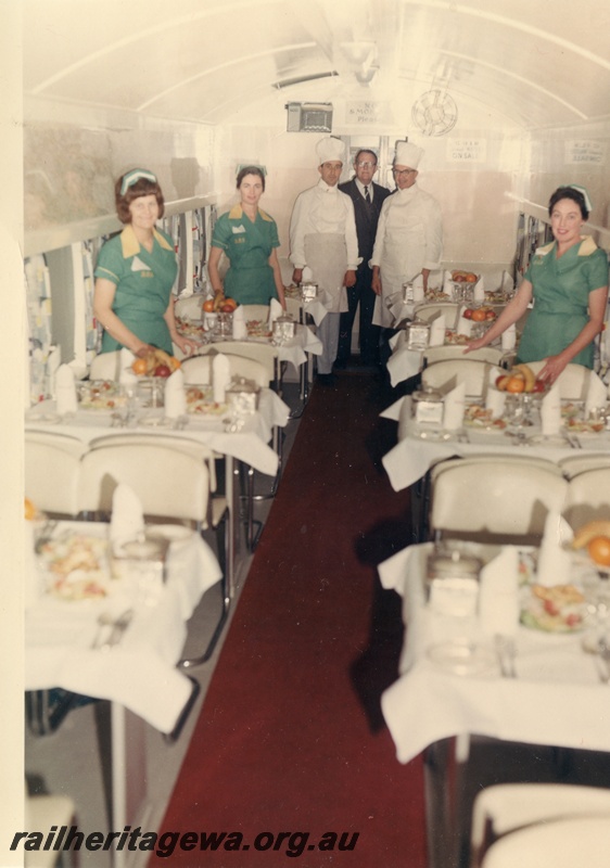 P03720
AV class dining car, interior view, set up for dining, staff pictured in uniform
