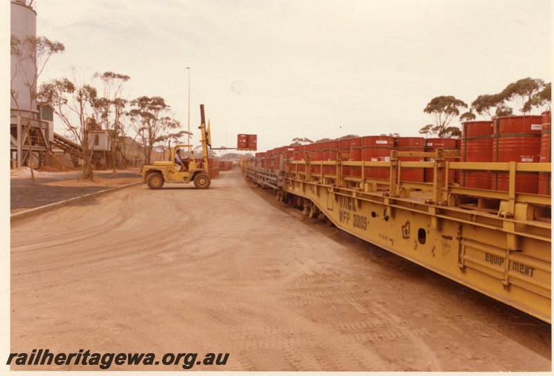 P04002
WFP class 30105 wagon, other WFP class wagons, (later reclassified to WFDY), drums being loaded by forklift, Hampton nickel refinery, view from fork lift side
