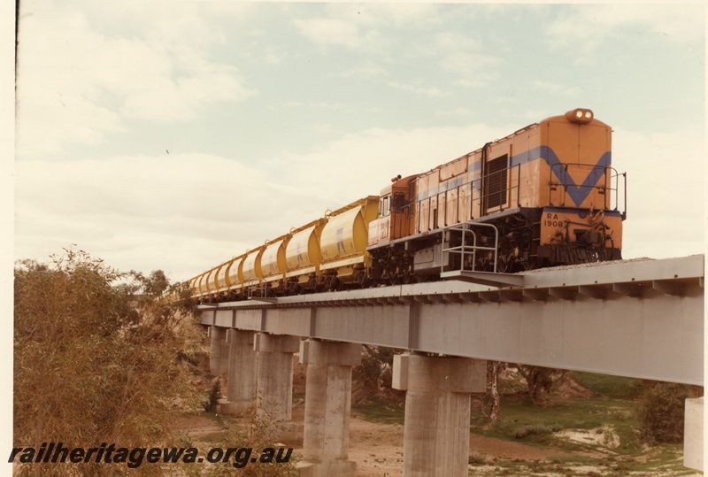 P04024
RA class 1908, Westrail orange with blue stripe, heading mineral sands train, crossing steel and concrete bridge, Irwin River
