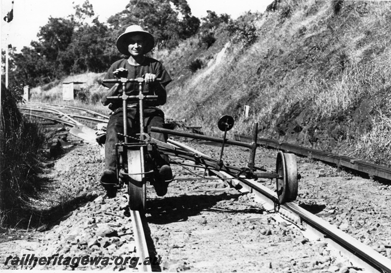 P04090
Gangers trolley, on track with seated man, coming towards camera, signal clear
