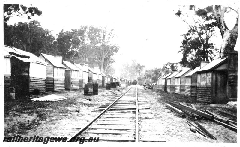 P04414
Timber worker's bush camp, rows of huts alongside the railway line, view along the line.
