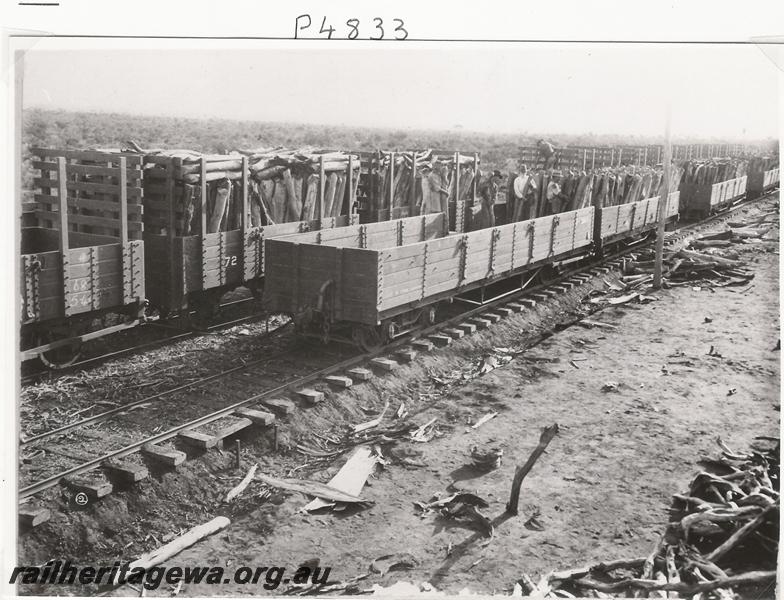 P04833
R class wagons, WAGFS Co. 4 wheel, wagons, Kurrawang, being loaded with firewood 
