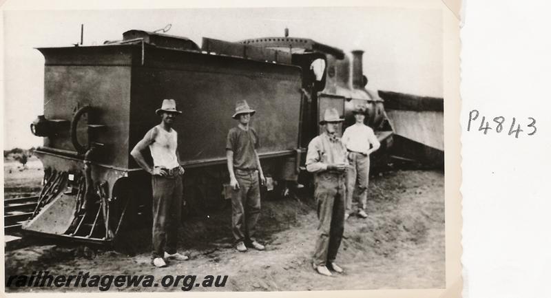 P04843
PWD G class 45 loco, wagons, rear view of tender with rear cowcatcher, workers in foreground, derailed wagon in background, derailment at the 328 mile, 28 chain location on the Wiluna Railway, NR line, date of derailment 12/11/1929
