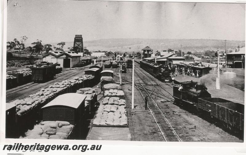P05325
Station yard with loaded wagons, scissors crossover with double slip, station building, signal box, goods shed and the 50,000 gallon water tower, Northam, ER line, elevated overall view taken from the footbridge looking west,
