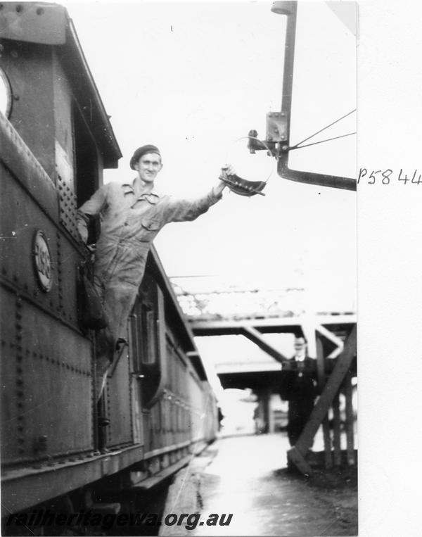 P05844
Fireman Keith Underwood changing the staff at East Perth on suburban passenger train to Armadale
