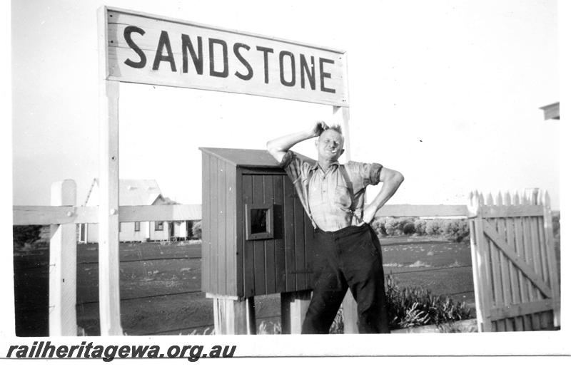 P06700
Nameboard, fire hose box, Driver N. Pirani posing under the nameboard, Sandstone, NR line
