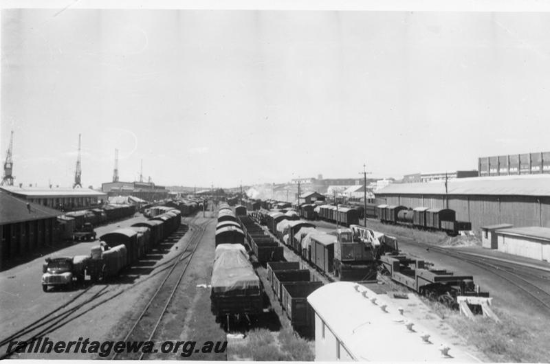 P06757
Yard, Fremantle, looking east, E shed and passenger terminal in background, QX class 2300 trolley wagon in foreground
