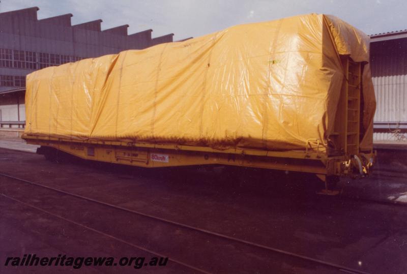 P06792
QUW class 25013, flat wagon adapted for transporting wool bales, side and end view showing load covered with tarpaulins.
