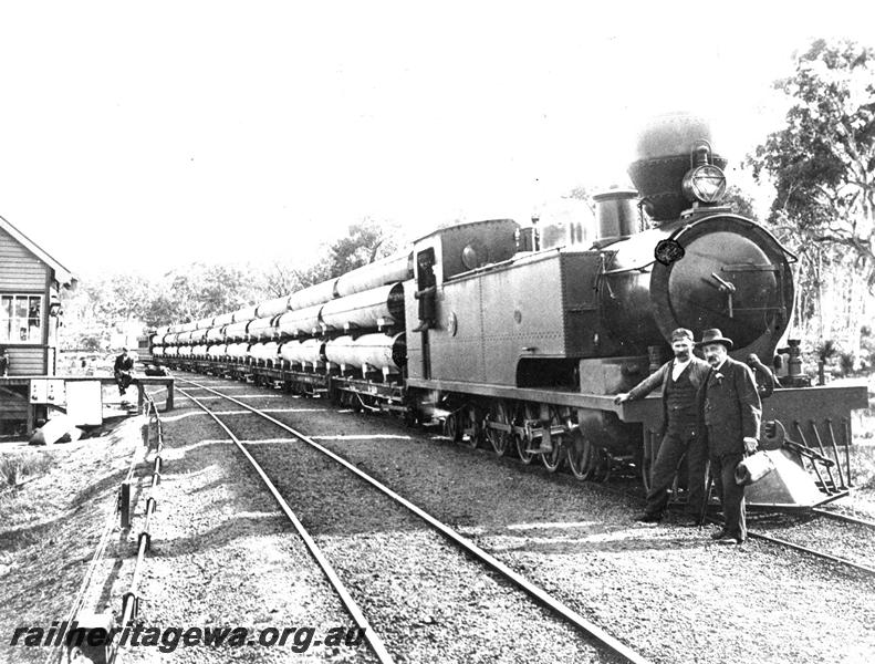 P07460
K class loco, signal box, hauling train load of pipes for the Eastern Goldfields Water Supply Scheme, ER line
