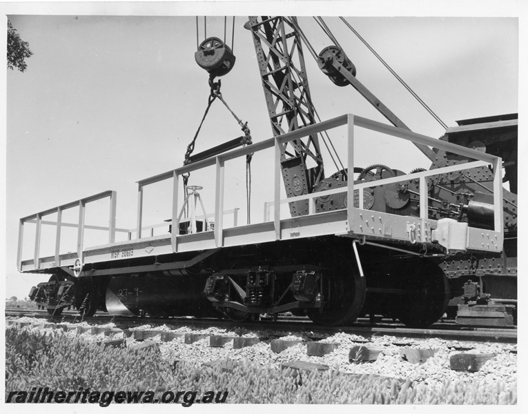 P10243
WSP class 30613 standard gauge ballast plough being lowered onto the track by Cravens breakdown crane No 23, side and end view
