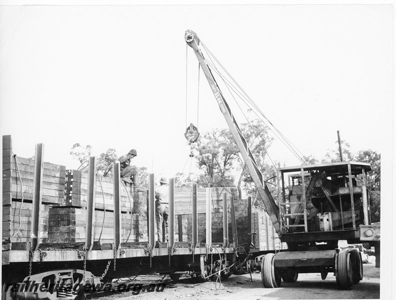 P10514
QCS class flat top wagon fitted with stanchions and end boards being loaded with sleepers by a mobile crane.
