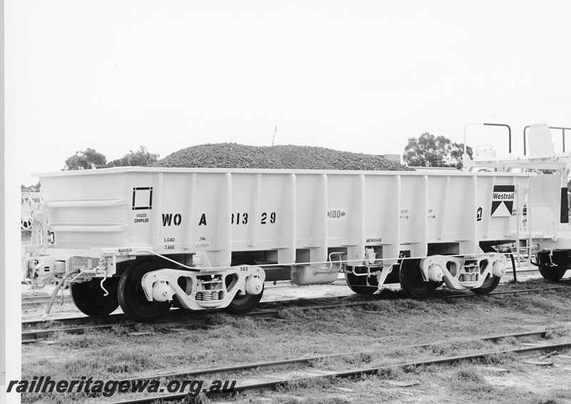P10518
WOA class 31329 iron ore wagon loaded with a demonstration load of ore. End and side view of wagon.
