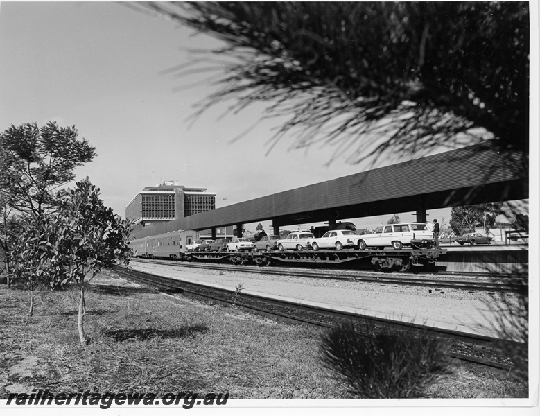 P10929
Photograph depicts an excellent side view of 2 RM class flat top wagons, loaded with passenger motor cars, after arrival at East Perth Terminal.
