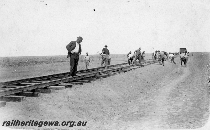 P16901
Commonwealth Railways (CR) - TAR line - construction workers using sledge hammers to install 