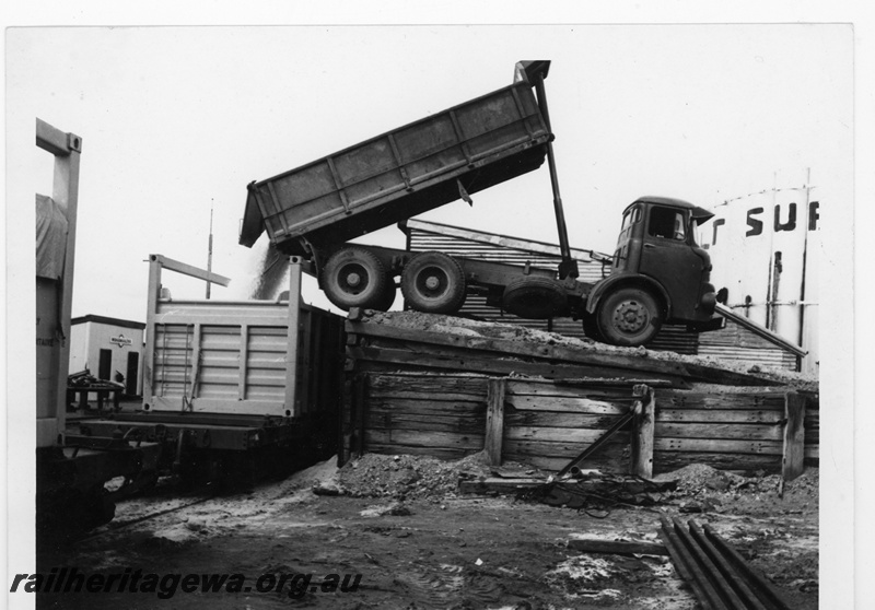 P16906
Truck tipping salt into COB container on narrow gauge flat wagon, Widgemooltha , CE line.
