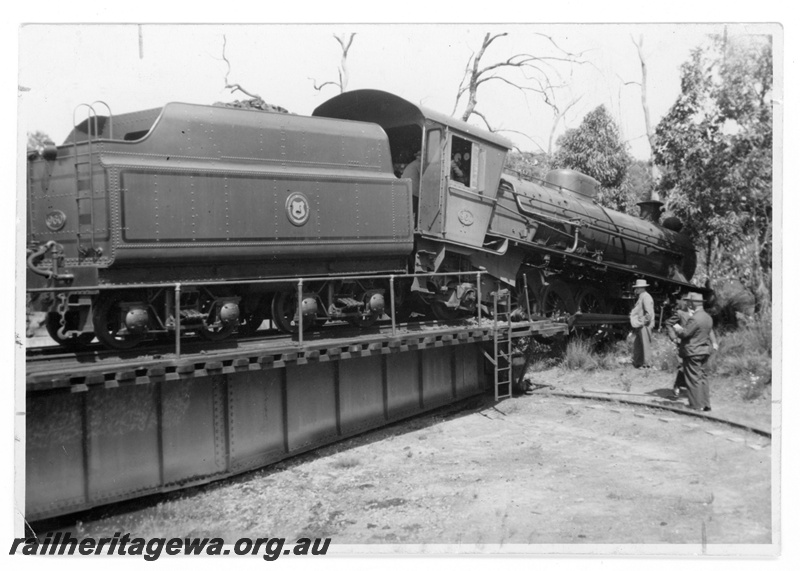 P16907
W class 960 having over run the turntable at Koojedda. tender remaining on the turntable, tender lined out with a WAGR roundal  (Mucky Duck) on the tender side, end and side view. Date of the incident 31/10/1952
