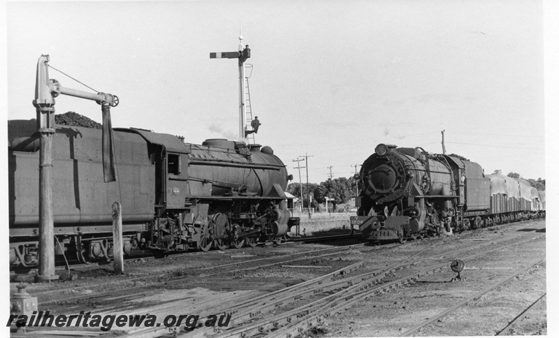 P17275
V class 1212 steam locomotive, side view, crossing V class 1206 steam locomotive on goods train, front and side view, water column, semaphore signal, cheese knob, points, Brookton yard, GSR line.
