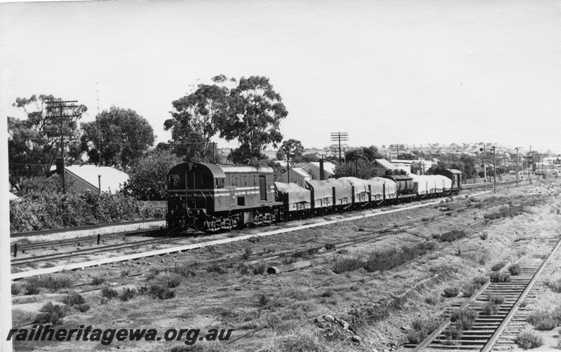 P17743
F class 43 diesel locomotive working a goods train to Goomalling after passing through East Northam. EM line. New standard gauge line to left of loco 
