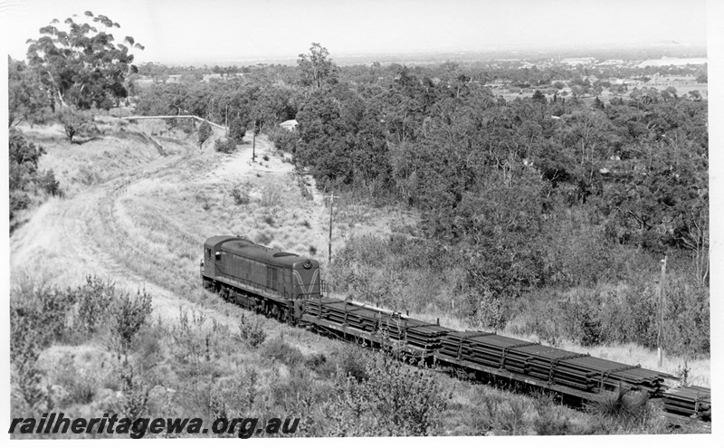 P17747
3 of 9 Rail reclamation on old ER line. C class 1701, short hood leading, on reclamation train laden with rails, pipe bridge in background, Swan View, ER line
