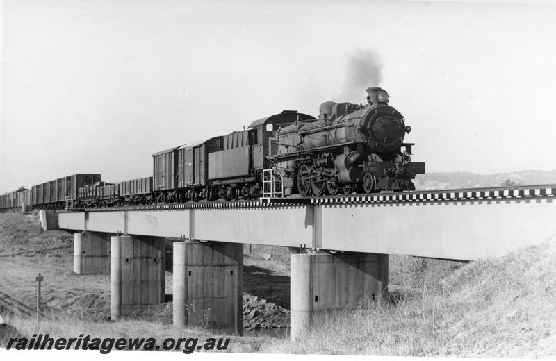 P17764
PMR class 732 steam locomotive with 23 goods on the Roelands Bridge. SWR line. Note the steel girder bridge and concrete pylons. 3/4 side view of locomotive and train.
