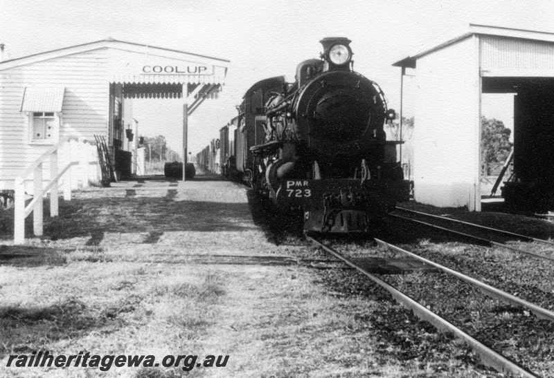 P17766
PMR class 723 steam locomotive with a goods train at Coolup. SWR line. Note station nameboard, station building and goods shed.
